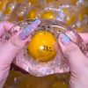 Coconut oil filled with cracking egg inside handmade ball soft squeeze anti-stress squishy toy