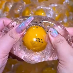 Coconut oil filled with cracking egg inside handmade ball soft squeeze anti-stress squishy toy